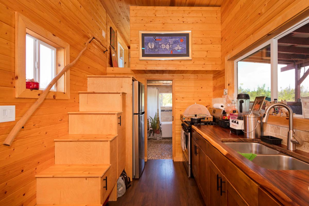 Kitchen with new energy saving full size appliances and lots of storage, facing towards bathroom and master sleeping loft